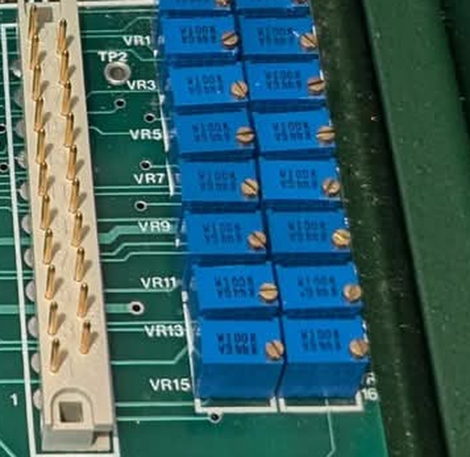 A bank of sixteen blue multiturn trimmers in two columns, with odd designators VR1, VR3, VR5, VR7, VR9, VR11, VR13 and VR15 silkscreened down the left edge and the test point TP2 alongside.