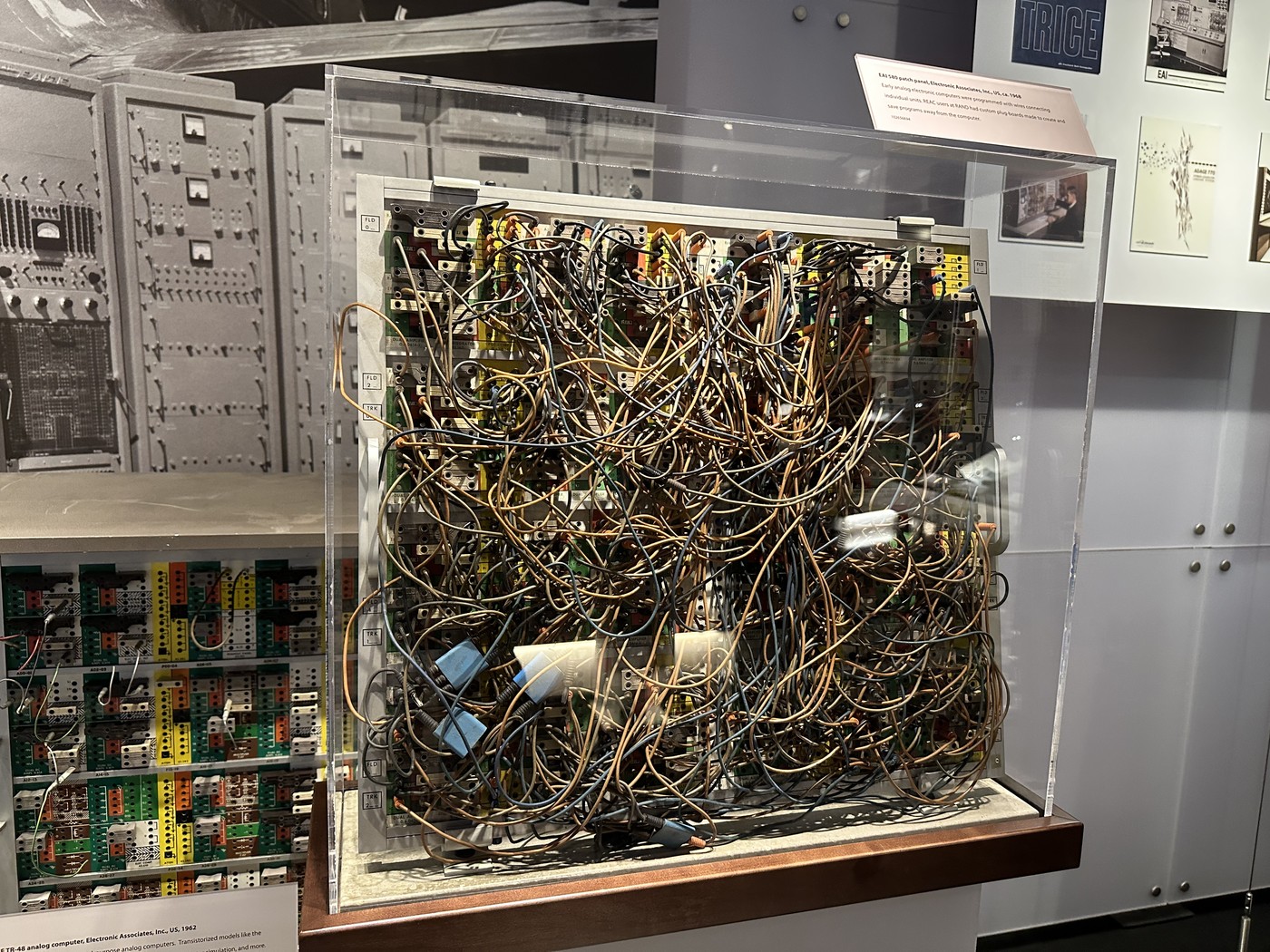 An EAI 580 problem board displayed in a museum case, densely filled with several hundred patch cords in a tangle.